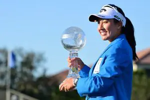Jeeno Thitikul lifting the CME Globe trophy at the 2025 CME Group Tour Championship after setting the all-time LPGA scoring record of 68.68.